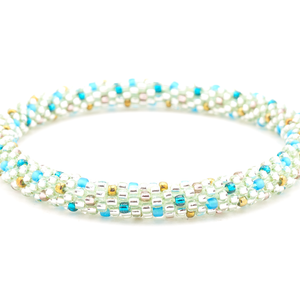 Sashka Co handmade beaded friendship bracelet with clear, teal, matte blue, purple, and bronze glass beads. Crafted in Nepal by skilled artisans in a polka dot pattern.