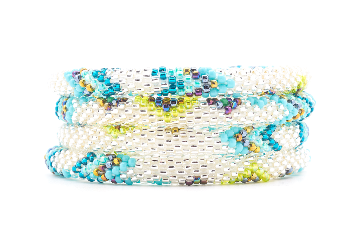 Sashka Co handmade beaded friendship bracelet with clear, turquoise, teal, iridescent green, aqua, and iridescent glass beads. Crafted in Nepal by skilled artisans in a chevron diamond pattern.