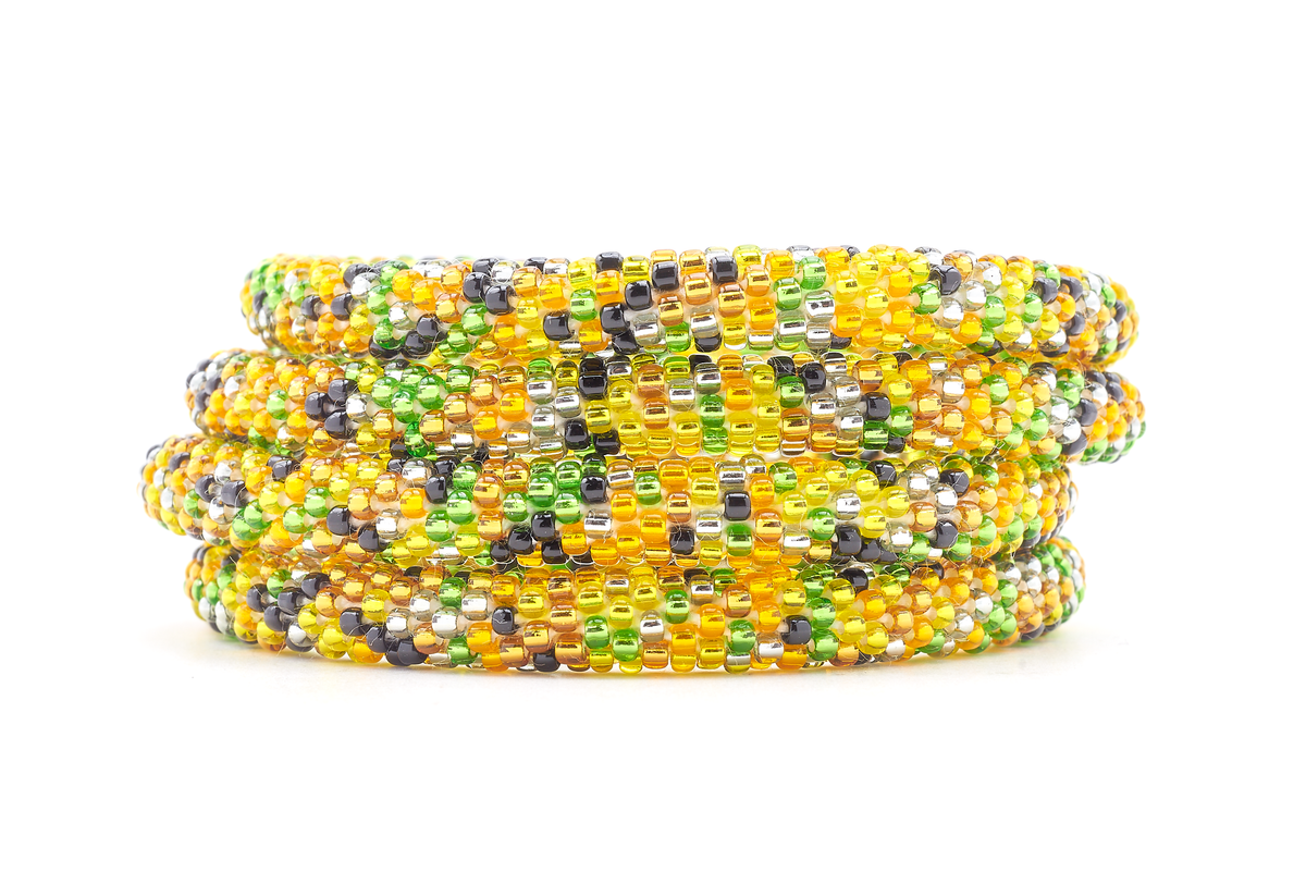 Sashka Co handmade beaded friendship bracelet with green, orange, yellow, black, and clear glass beads. Crafted in Nepal by skilled artisans in a confetti pattern.