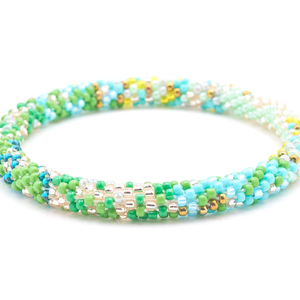 Sashka Co handmade beaded friendship bracelet with green, teal, rose gold, clear, turquoise, yellow, mint, and bronze glass beads. Crafted in Nepal by skilled artisans in a confetti mixed pattern.

