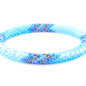 Sashka Co handmade beaded friendship bracelet with iridescent blue, iridescent clear, iridescent, and matte iridescent blue glass beads. Crafted in Nepal by skilled artisans in an arrow pattern.