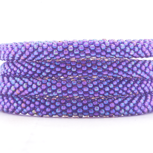 Sashka Co handmade beaded friendship bracelet with solid iridescent purple glass beads. Crafted in Nepal by skilled artisans.