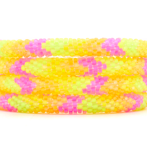 Sashka Co handmade beaded friendship bracelet with neon pink, neon yellow, and neon orange glass beads. Crafted in Nepal by skilled artisans in a chevron pattern.