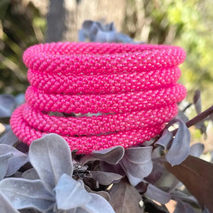 Sashka Co handmade beaded friendship bracelet with neon pink glass beads. Crafted in Nepal by skilled artisans in a solid pattern.