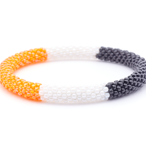 Sashka Co. handmade beaded friendship bracelet with orange, white, and black block pattern. Crafted in Nepal by skilled artisans.