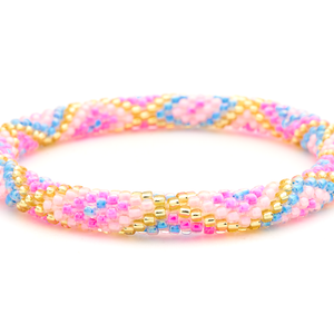Sashka Co handmade beaded friendship bracelet with pink, light pink, blue, and champagne gold glass beads. Crafted in Nepal by skilled artisans in a criss cross pattern.