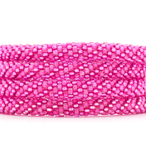 Sashka Co handmade beaded friendship bracelet with pink and metallic pink spiral pattern. Crafted in Nepal by skilled artisans.