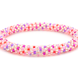 Sashka Co handmade beaded friendship bracelet with pink, purple, red, and rose gold polka dot spiral pattern. Crafted in Nepal by skilled artisans.