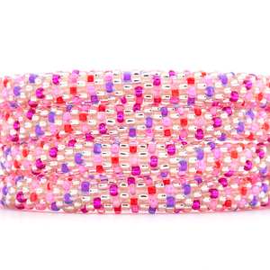 Sashka Co handmade beaded friendship bracelet with pink, purple, red, and rose gold polka dot spiral pattern. Crafted in Nepal by skilled artisans.