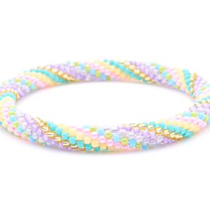 Sashka Co. handmade beaded friendship bracelet with purple, pink, turquoise, green, champagne gold, and matte yellow spiral pattern. Crafted in Nepal by skilled artisans.