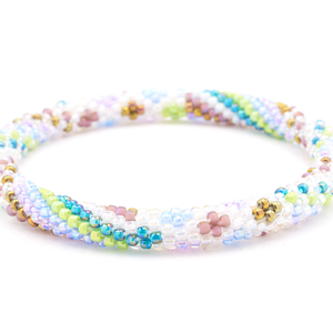Sashka Co handmade beaded friendship bracelet with a diamond spiral of iridescent clear, mauve, teal, green, purple, lavender, and bronze glass beads. Crafted in Nepal by skilled artisans.