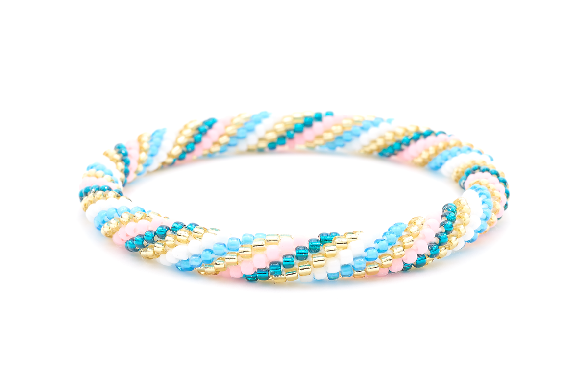 Sashka Co. handmade beaded friendship bracelet with teal, champagne gold, white, blue, and matte pink spiral pattern. Crafted in Nepal by skilled artisans.