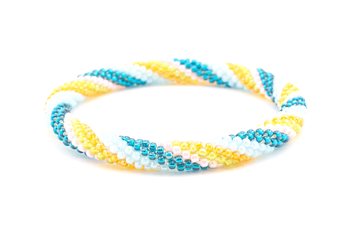 Sashka Co handmade beaded friendship bracelet with teal, mint, orange, green, and pink glass beads. Crafted in Nepal by skilled artisans in a spiral pattern.