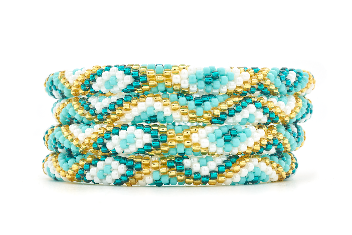 Sashka Co handmade beaded friendship bracelet with turquoise, teal, white, and champagne gold diamond pattern. Crafted in Nepal by skilled artisans.