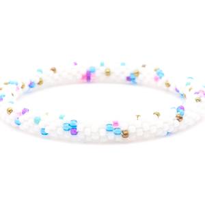 Sashka Co. handmade beaded friendship bracelet with white, blue, pink, purple, and bronze playful pattern. Crafted in Nepal by skilled artisans.