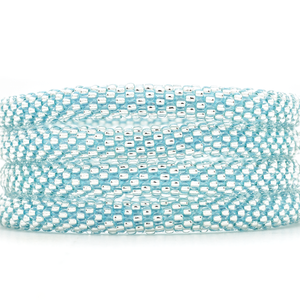 Handmade glass bead Clear with Blue Thread bracelet from Nepal, featuring a roll design. Also known as a beaded bracelet, seed bead bracelet, beach glass bracelet, or sea glass bracelet