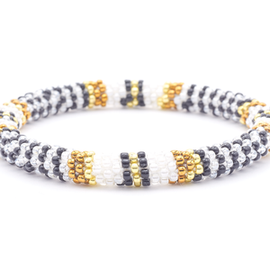 Sashka Co. handmade glass beaded friendship bracelet with white, black, brown, and gold glass beads. Crafted in Nepal by skilled artisans.