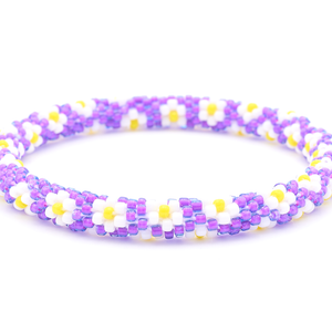 Sashka Co. handmade beaded friendship bracelet with purple, white, and yellow flower pattern. Crafted in Nepal by skilled artisans.