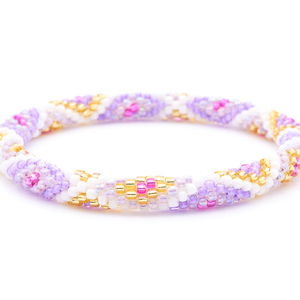 Sashka Co. handmade beaded friendship bracelet with iridescent purple, purple, fuchsia, champagne gold, and white glass beads. Crafted in Nepal by skilled artisans in a diamond pattern.