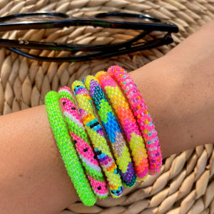 Stack of 6 colorful Sashka Co. Bracelet on a wrist