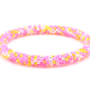 Handmade beaded friendship bracelet with matte pink, pink, yellow, orange, and clear glass beads. Crafted by artisans in Nepal for Sashka Co.