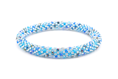 Sashka Co. Blue, Clear, Iridescent Bracelet. Handmade glass bead bracelet from Nepal, featuring a roll design.
 