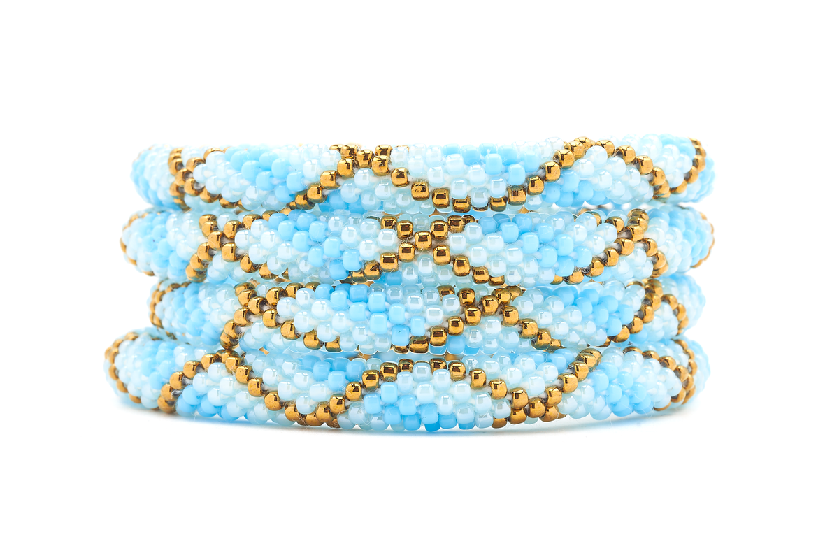 Sashka Co. Blue, Light Blue, Bronze Bracelet. Handmade glass bead bracelet from Nepal, featuring a roll design.
 