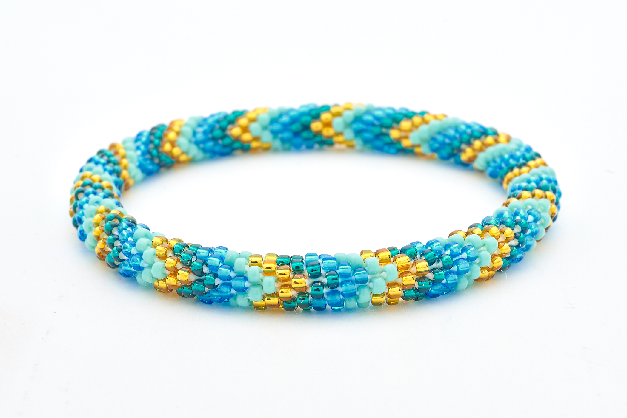 Handmade glass bead Blue , Gold , Teal , Turquoise bracelet from Nepal, featuring a roll design. Also known as a beaded bracelet, seed bead bracelet, beach glass bracelet, or sea glass bracelet