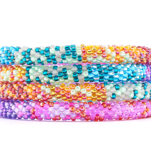 Sashka Co. Mixed Purples, Blues, Gray, Orange, Reds, Pinks Bracelet. Handmade glass bead bracelet from Nepal, featuring a roll design.