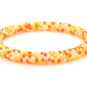 Handmade glass bead mixed oranges and clear bracelet from Nepal, featuring a roll design. Also known as a beaded bracelet, seed bead bracelet, beach glass bracelet, or sea glass bracelet