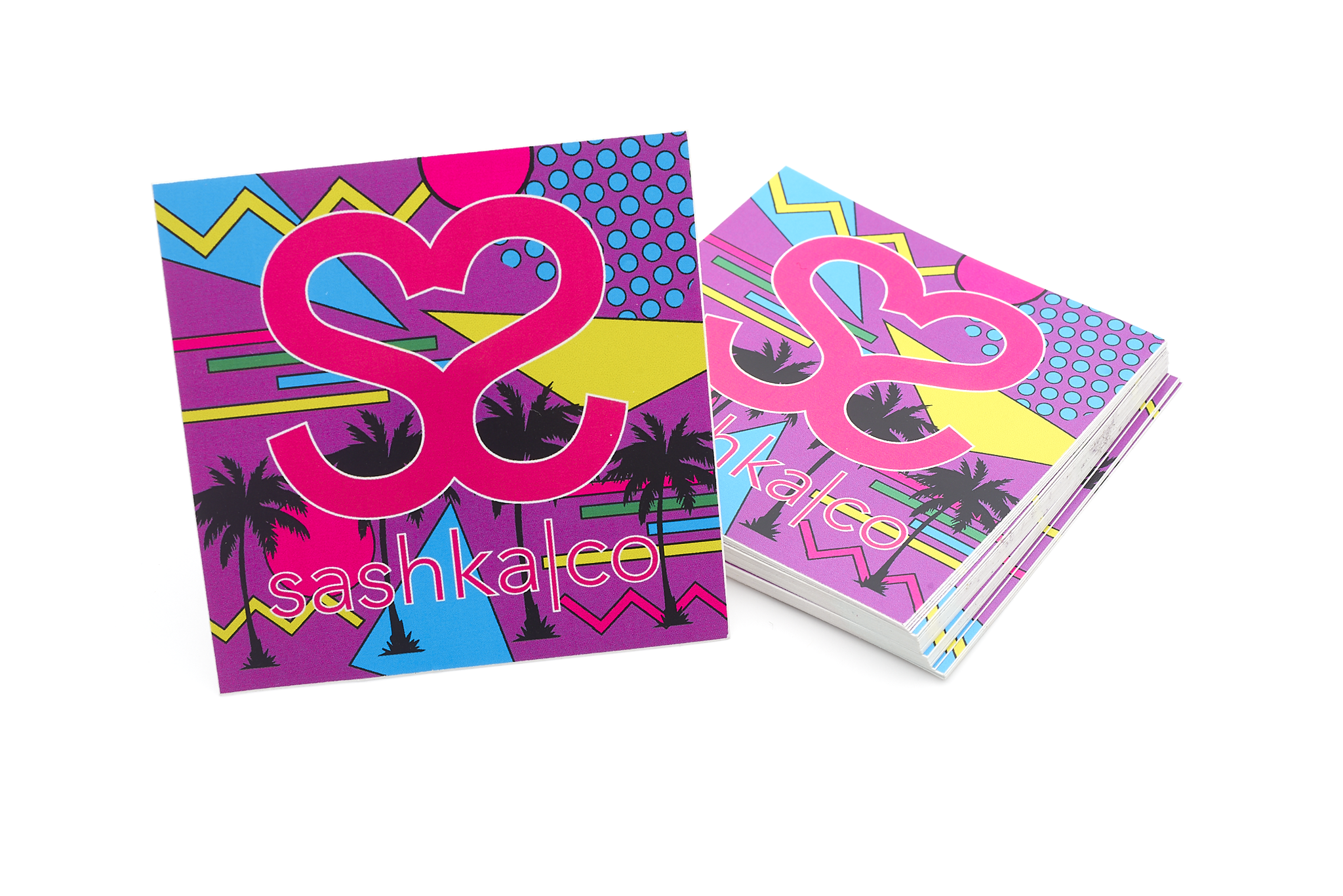Colorful Sashka Co sticker with retro vibe, logo, palm trees, and geometric pop art design in pink, purple, yellow, and blue.