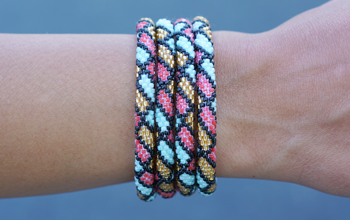 Sashka Co. red, gold, mint, black Art Love Bracelet. Handmade glass bead bracelet from Nepal, featuring a roll design.