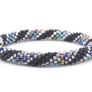 Sashka Co. handmade glass beaded friendship bracelet with black, clear and confetti glass beads in a confetti spiral pattern. Crafted in Nepal by skilled artisans.