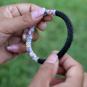 Sashka Co handmade beaded friendship bracelet with black and mixed confetti glass beads in a half-and-half design. Crafted in Nepal by skilled artisans.