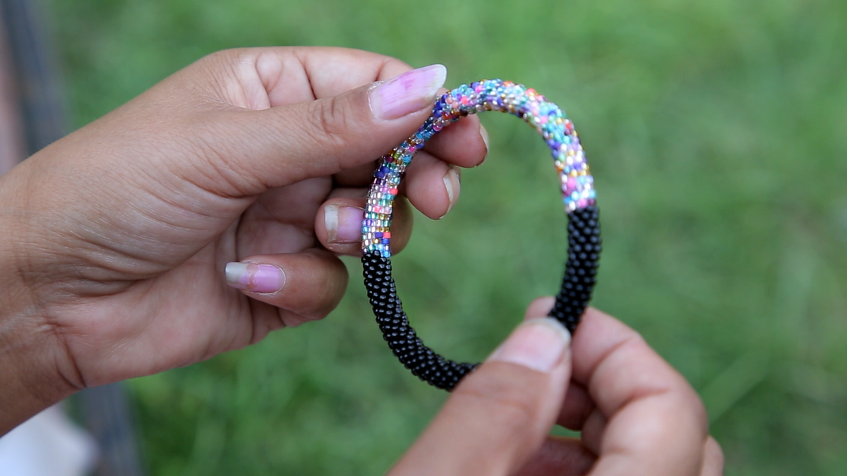 Sashka Co handmade beaded friendship bracelet with black and mixed confetti glass beads in a half-and-half design. Crafted in Nepal by skilled artisans.