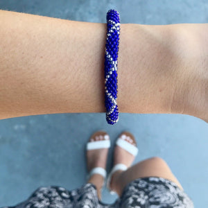 Sashka Co. handmade glass beaded friendship bracelet with blue and clear glass beads in a criss cross pattern. Crafted in Nepal by skilled artisans.