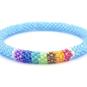 Sashka Co. handmade glass beaded friendship bracelet with blue, clear, red, orange, brown, green, turquoise, and purple glass beads in a chakra pattern. Crafted in Nepal by skilled artisans.