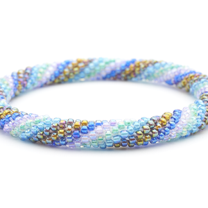 Sashka Co handmade beaded friendship bracelet with blue, purple, aqua, and iridescent glass beads. Crafted in Nepal by skilled artisans.