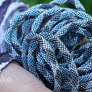 Sashka Co. handmade glass beaded friendship bracelet with blue, silver, and clear glass beads in a diamond pattern. Crafted in Nepal by skilled artisans.