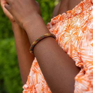 Sashka Co handmade beaded friendship bracelet with bronze, burnt orange, and mixed iridescent glass beads. Crafted in Nepal by skilled artisans.
