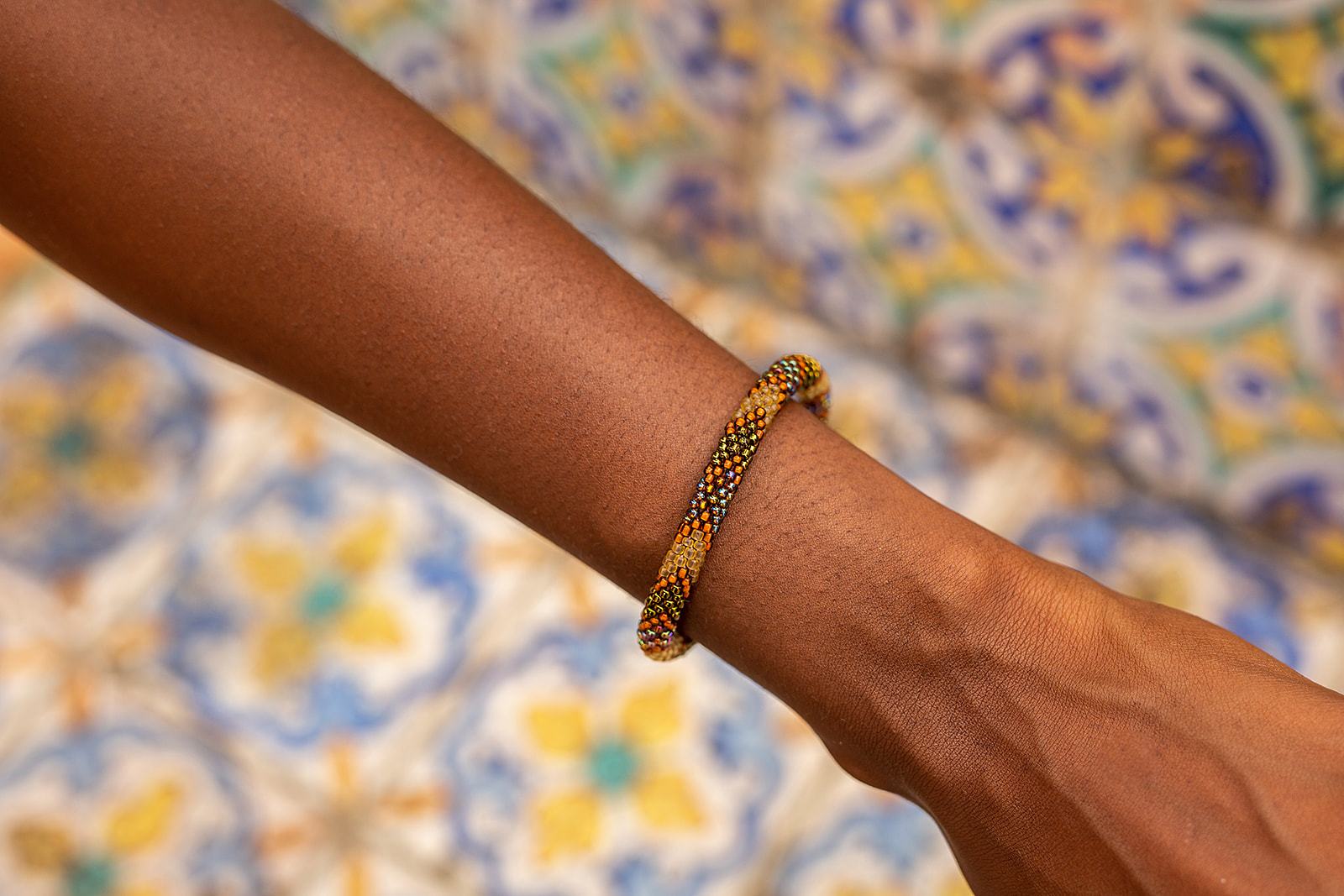 Sashka Co handmade beaded friendship bracelet with bronze, burnt orange, and mixed iridescent glass beads. Crafted in Nepal by skilled artisans.
