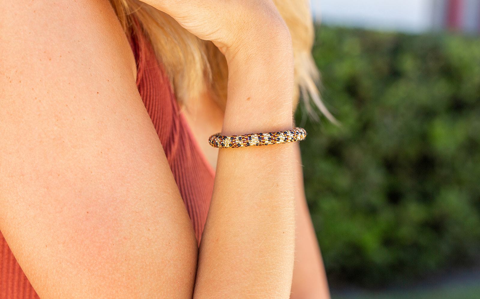 Sashka Co. handmade glass beaded friendship bracelet with brown, gold, and black glass beads. Crafted in Nepal by skilled artisans.
