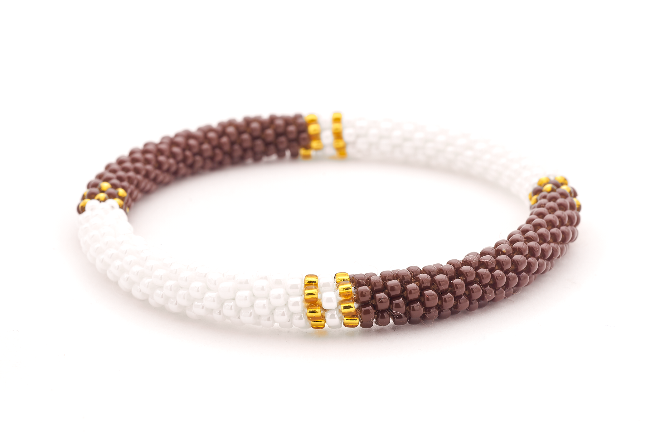 Sashka Co. handmade glass beaded friendship bracelet with brown, white, and gold glass beads in a half and half pattern. Crafted in Nepal by skilled artisans.