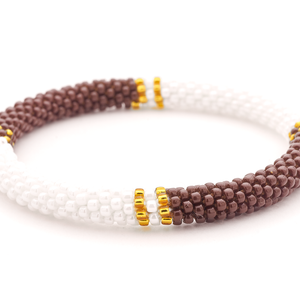 Sashka Co. handmade glass beaded friendship bracelet with brown, white, and gold glass beads in a half and half pattern. Crafted in Nepal by skilled artisans.