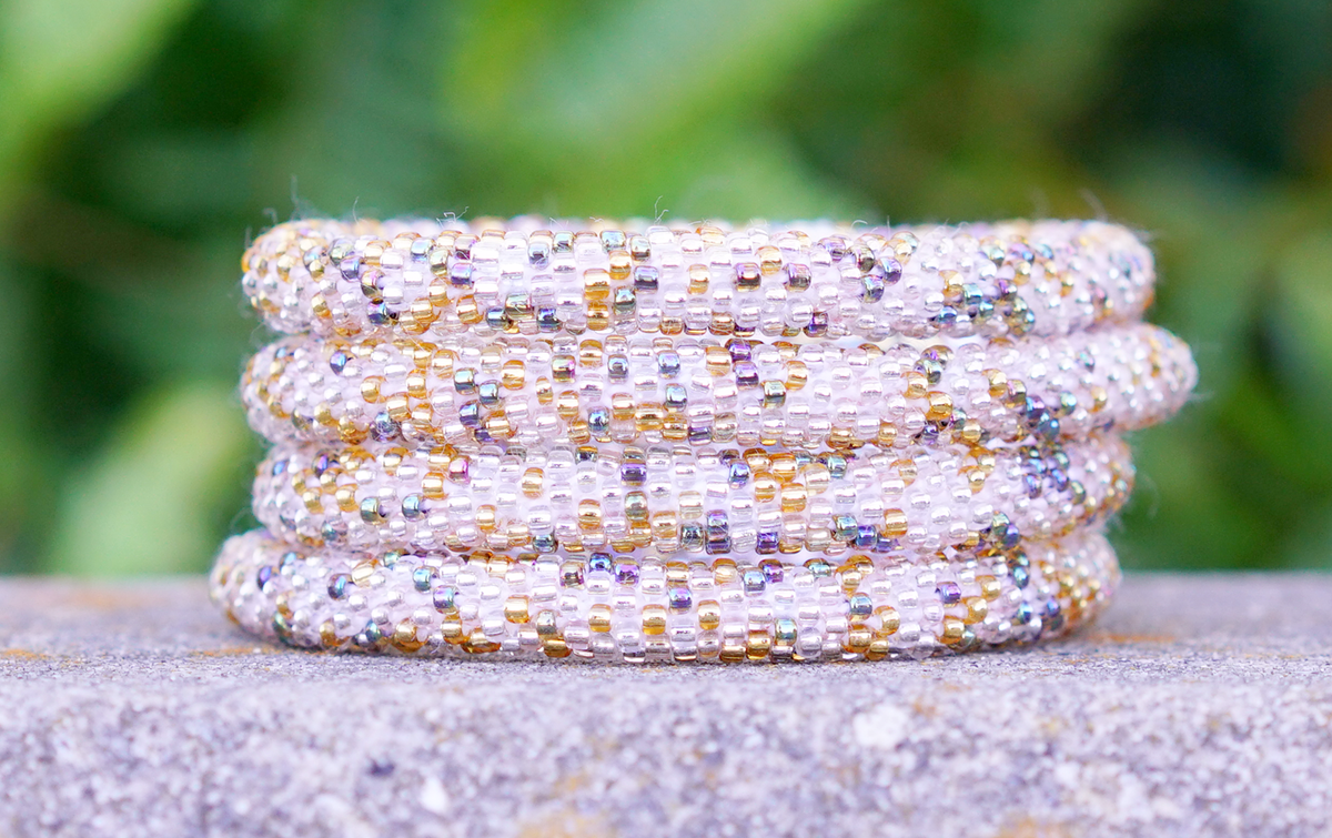 Sashka Co. handmade glass beaded friendship bracelet with clear, gold, and iridescent glass beads in a mixed pattern. Crafted in Nepal by skilled artisans.