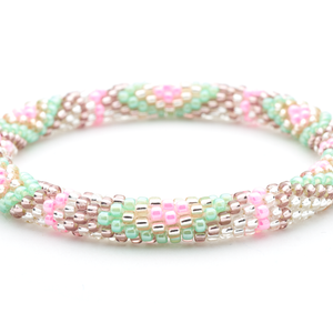 Handmade beaded friendship bracelet with clear, rose gold, purple, pink, and mint glass beads. Crafted by artisans in Nepal for Sashka Co.