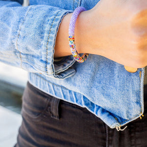 Sashka Co. handmade glass beaded friendship bracelet with confetti and solid light purple glass beads. Crafted in Nepal by skilled artisans.