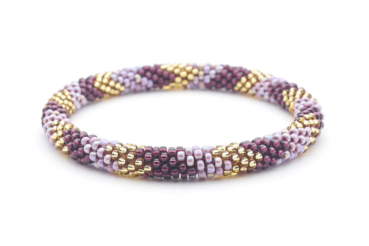 Sashka Co. handmade glass beaded friendship bracelet with deep purple, iridescent mauve, and champagne gold glass beads in a chevron pattern. Crafted in Nepal by skilled artisans.