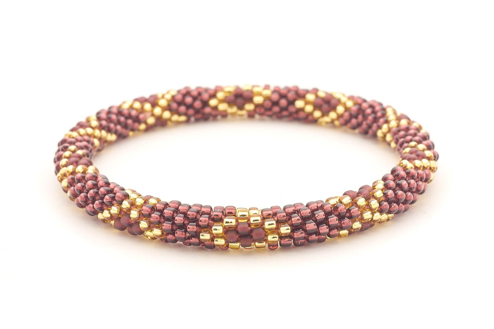 Sashka Co. handmade glass beaded friendship bracelet with gold and plum glass beads in a diamond pattern. Crafted in Nepal by skilled artisans.