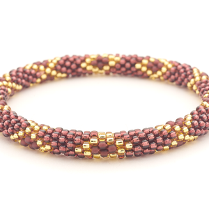 Sashka Co. handmade glass beaded friendship bracelet with gold and plum glass beads in a diamond pattern. Crafted in Nepal by skilled artisans.